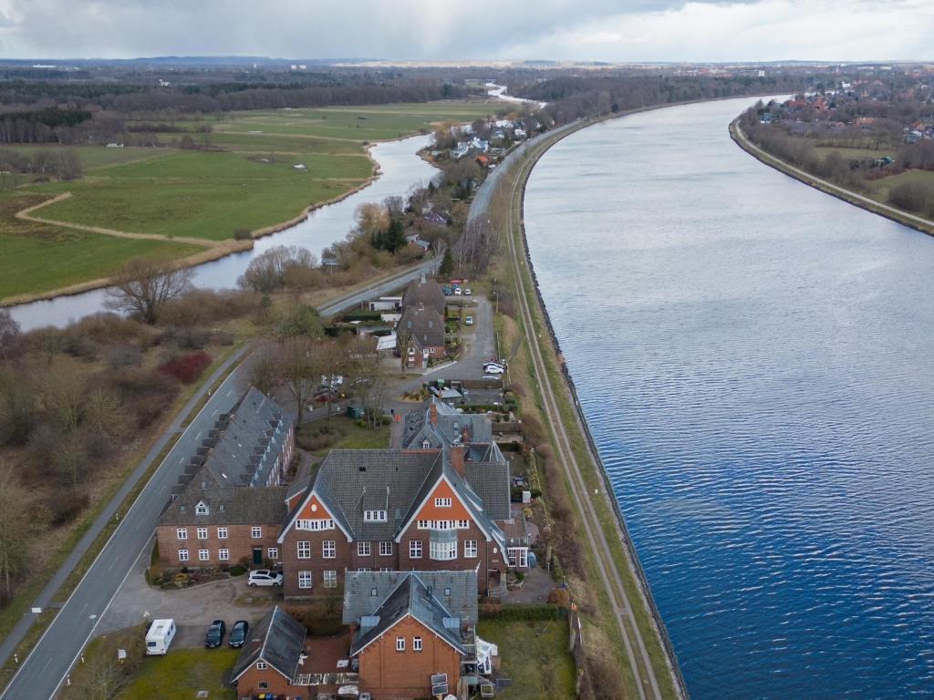 an aerial view of a house next to a river at Lotsenstation am Nord Ostsee Kanal in Schülp