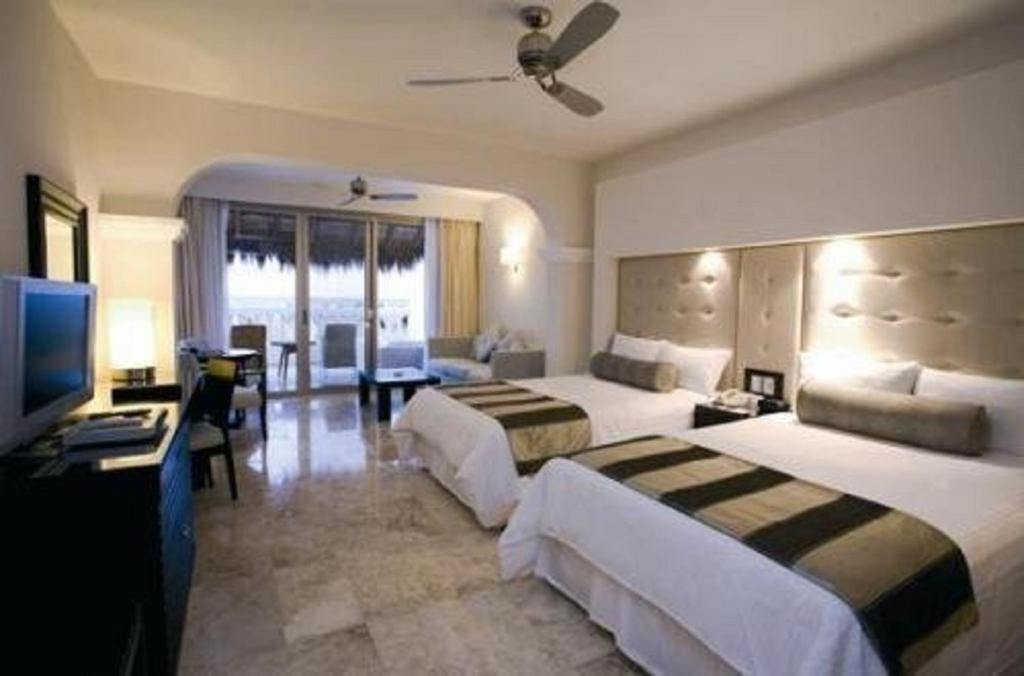 Una cama o camas en una habitación de Grand Riviera Princess - All Inclusive