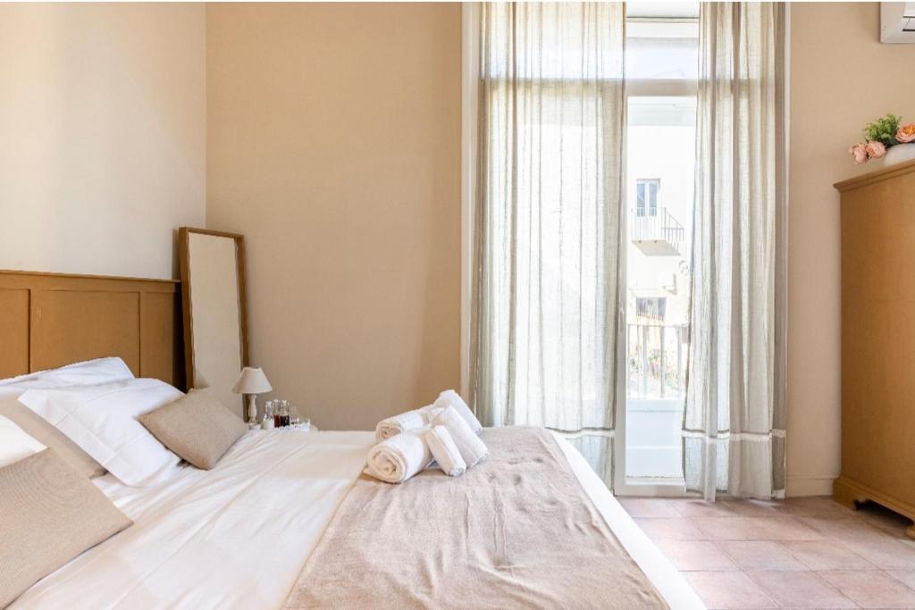 Postel nebo postele na pokoji v ubytování Joy's Bnb Ortigia