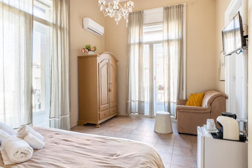 Postel nebo postele na pokoji v ubytování Joy's Bnb Ortigia