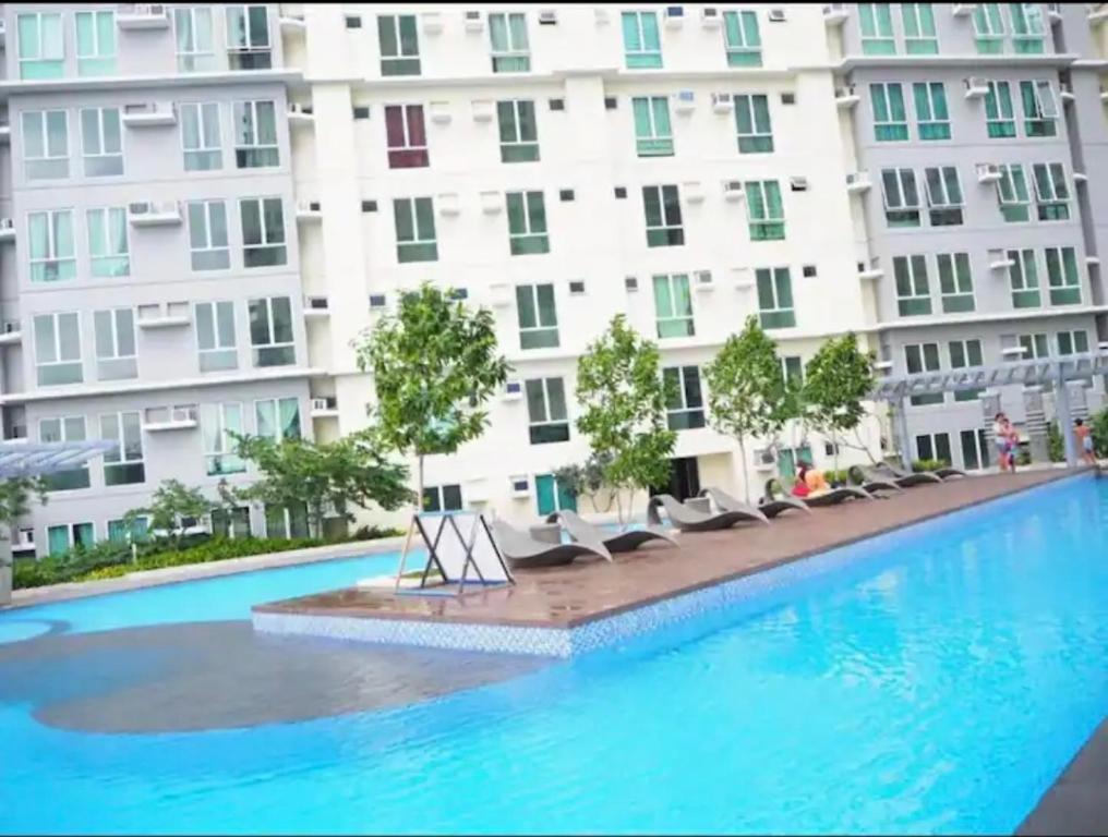 a large swimming pool in front of a building at San Lorenzo place condo in Manila