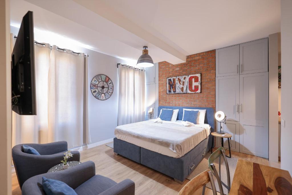 a bedroom with a king sized bed and a couch at Elegance Studio Apartments in Zadar