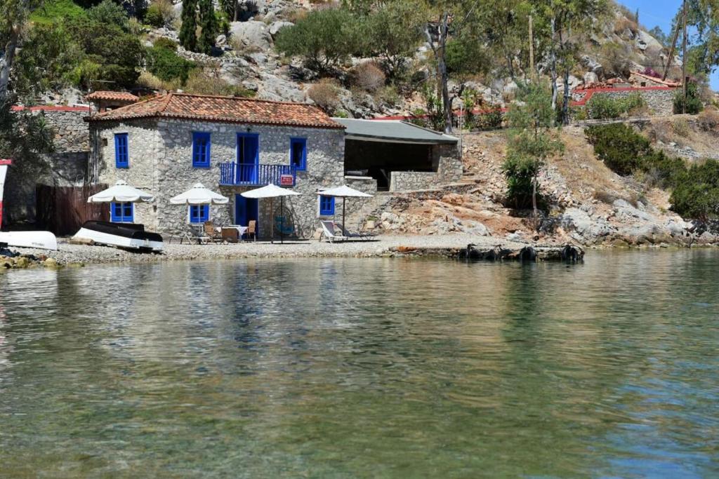 a house on the shore of a body of water at Douskos by the Sea in Mandraki