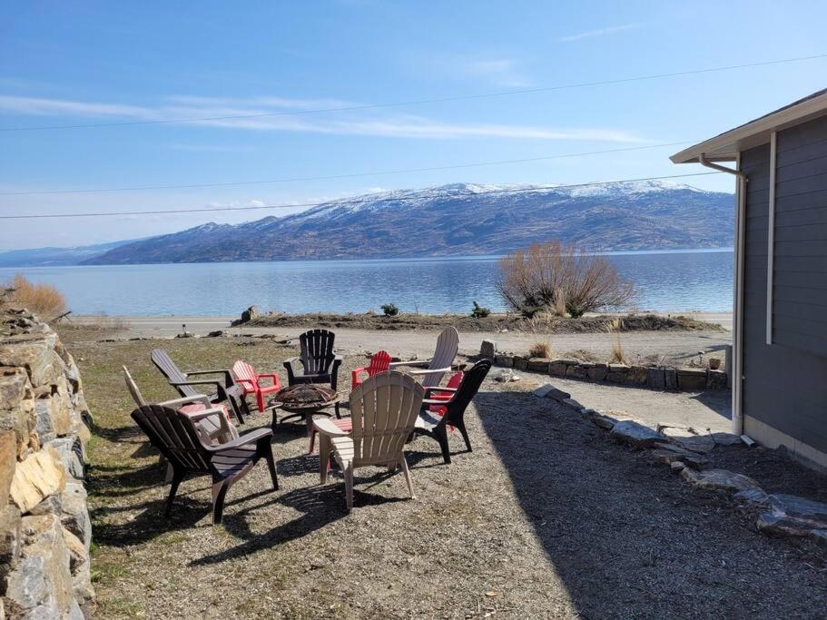a group of chairs and tables with a view of a lake at Lakeview in Peachland