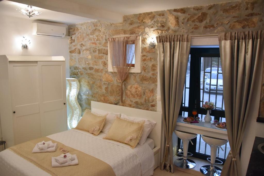 a bedroom with a bed with towels on it at Apartments Bepina in Split