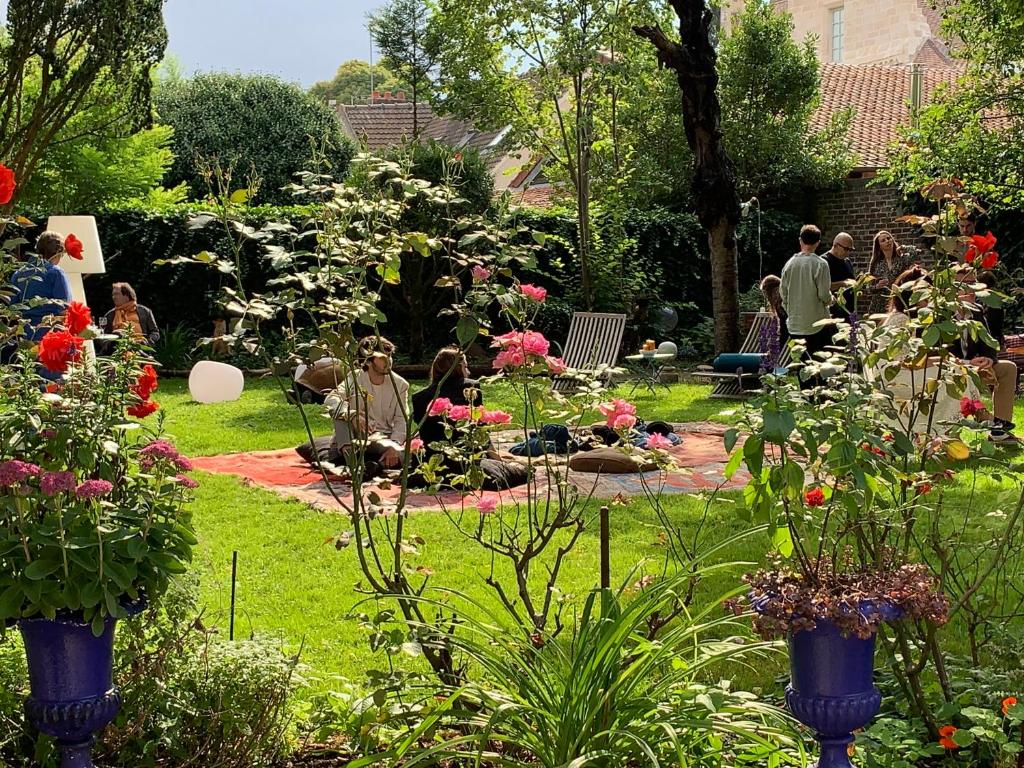 a group of people sitting in a garden at La Maison Saint Joseph in Crépy-en-Valois