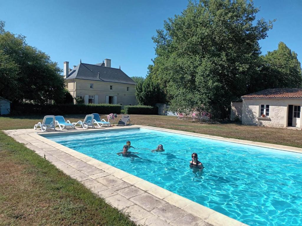 a group of people swimming in a swimming pool at Demeure de Maugé in Saint-Léger-de-Montbrillais