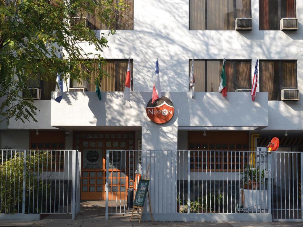 ein Gebäude mit Flaggen auf der Seite in der Unterkunft Hotel Nippon y Centro de Eventos in Santiago