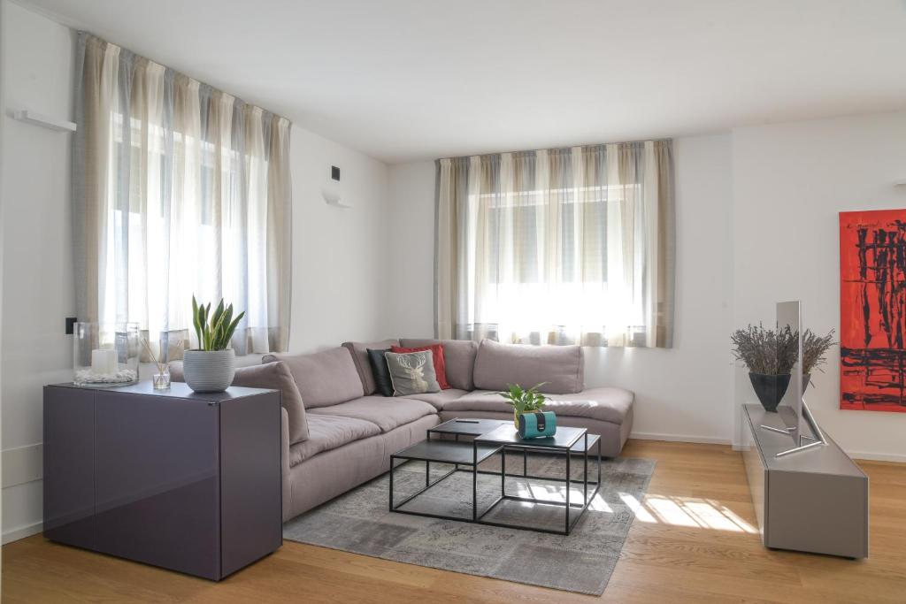 a living room with a couch and a table at Casa Riccardo in Levico Terme