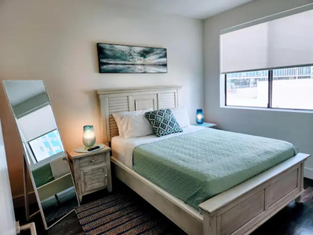 a bedroom with a large bed and a mirror at Marina Del Rey Resort Style Apartment I Free Parking in Los Angeles