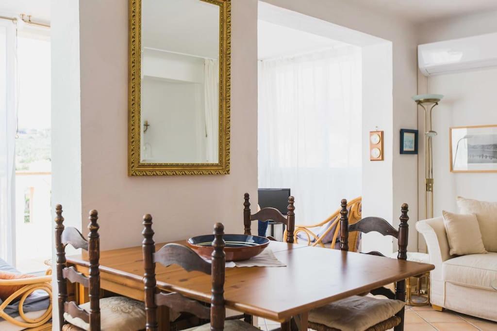a dining room with a table and a mirror at Regina's Banyuls - Mountain view in Banyuls-sur-Mer