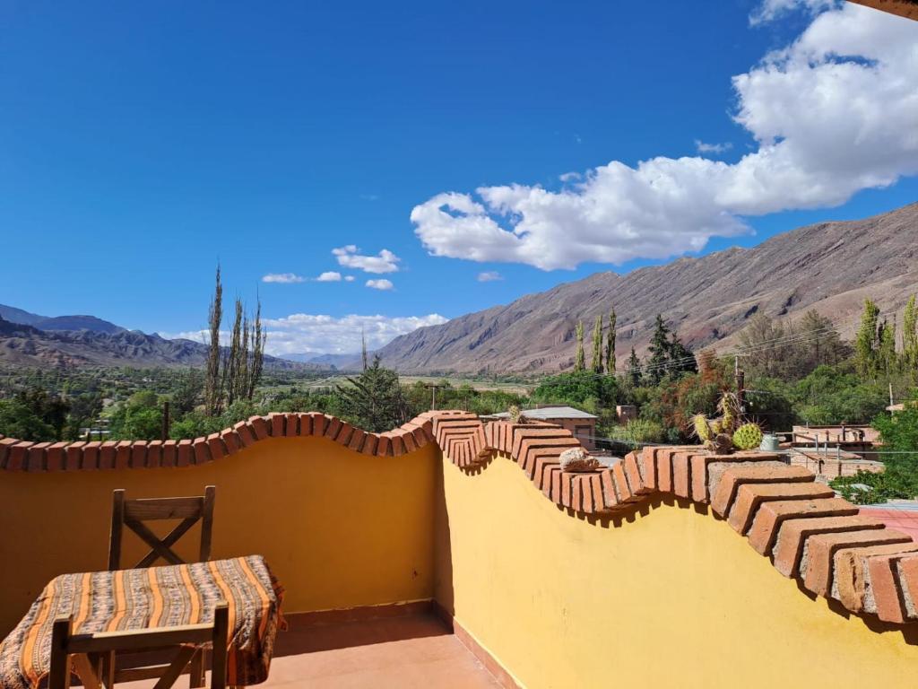 a balcony with a view of the mountains at Carnavalito Hostel Tilcara in Tilcara