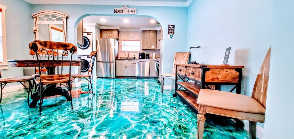 a kitchen with a floor that is covered in water at The Beachy Bungalow w/King Bed, near Dtwn & Beach in St. Petersburg