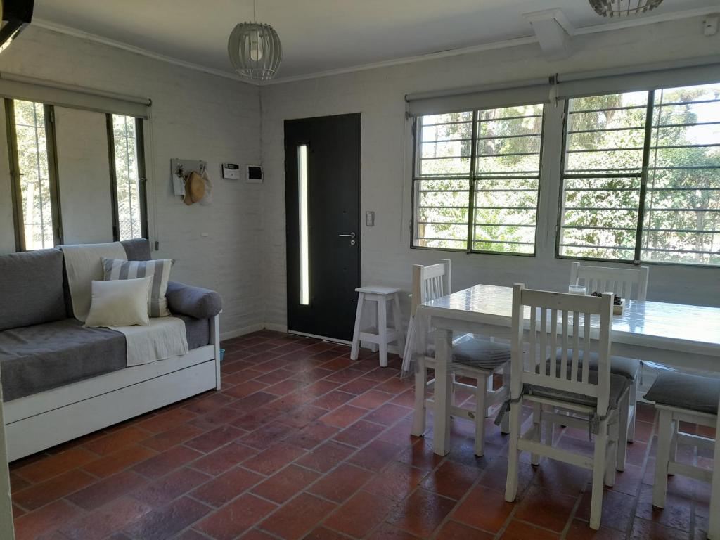 a living room with a couch and a table and chairs at Casa Quinta Las Casuarinas in Mercedes