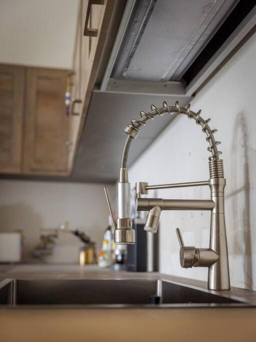 a sink in a kitchen with a faucet at Luxury en-suite Double. Beach-house with Sea Views in Mellieħa
