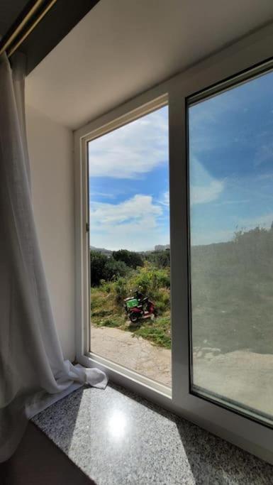a window in a room with a view of the ocean at Luxury en-suite Double. Beach-house with Sea Views in Mellieħa