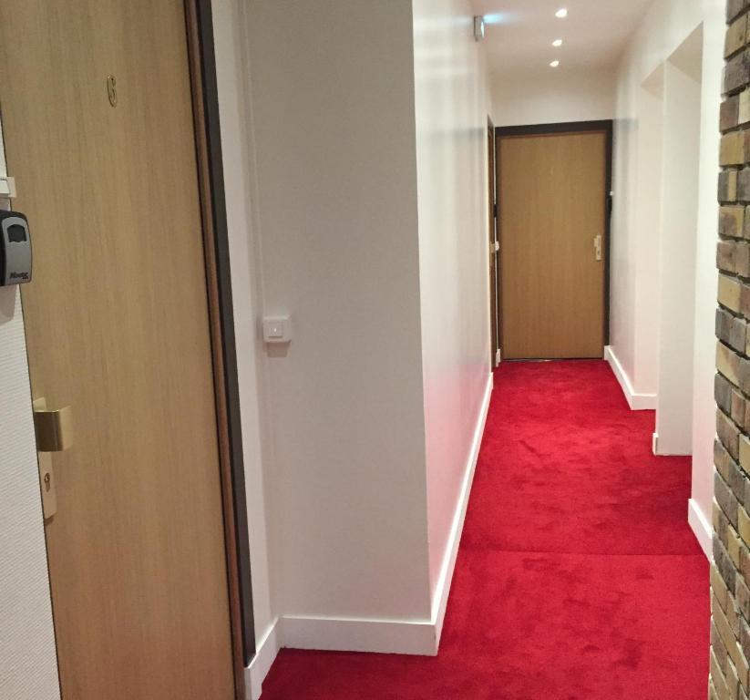 a hallway with a red carpet and a door at Tour Eiffel Beaugrenelle in Paris
