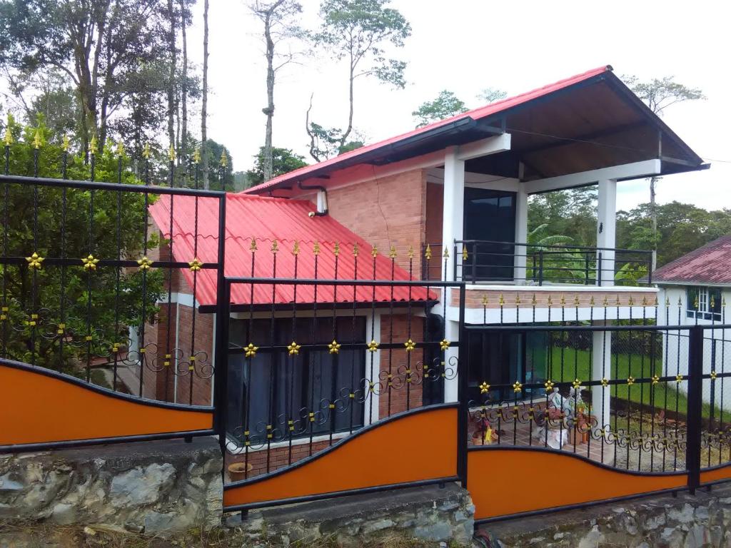 a house with a balcony with a fence at CABAÑA 5-1 CONDOMINIO LOS SAUCES MONIQUIRA in Moniquirá