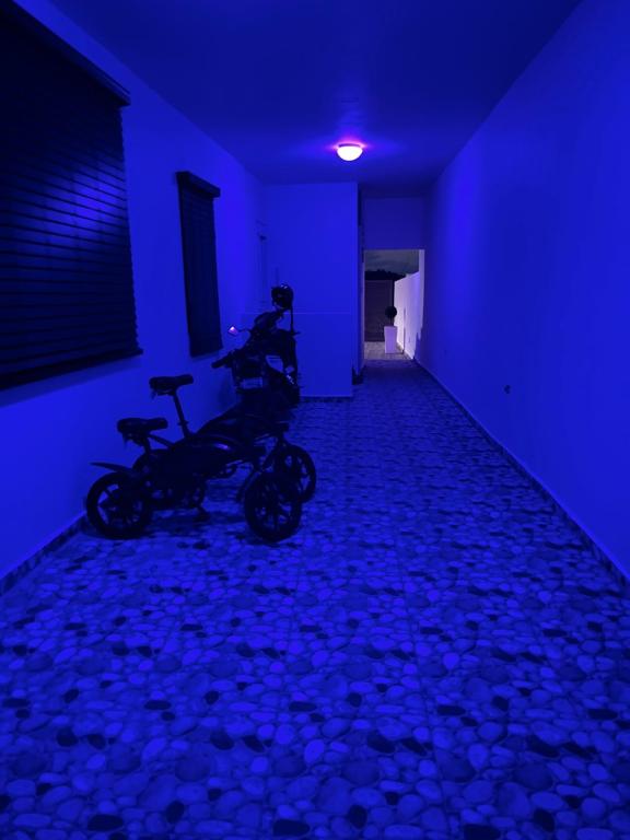 a room with a motorcycle parked in a blue room at Satisfaction in San Juan