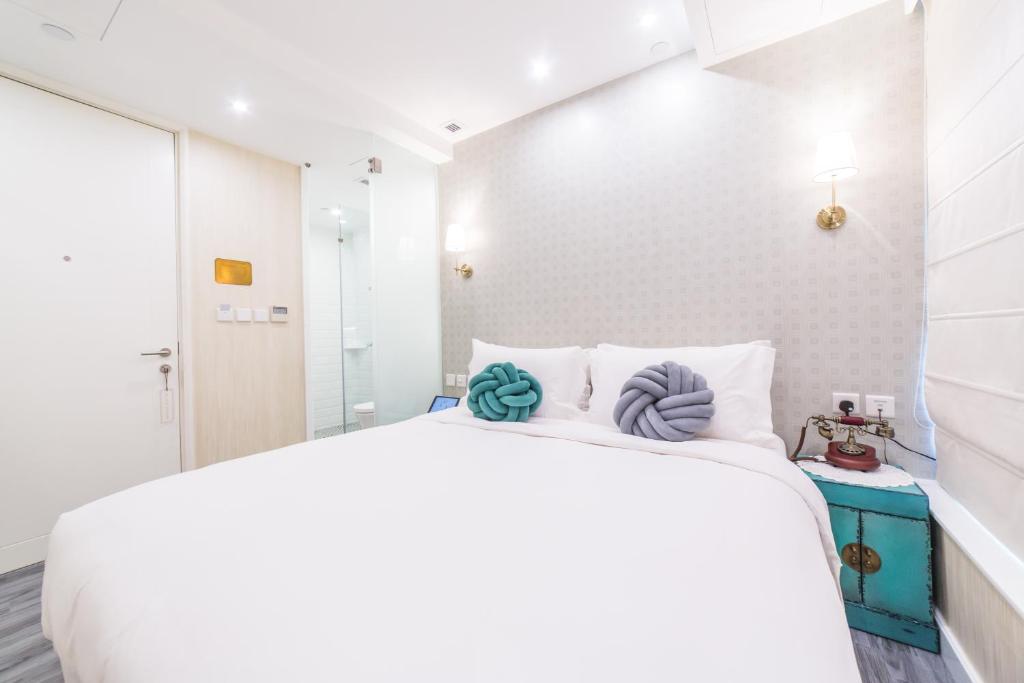 Voodi või voodid majutusasutuse Tung Nam Lou Art Hotel toas