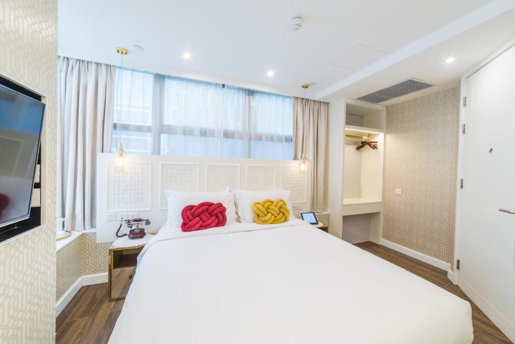 Voodi või voodid majutusasutuse Tung Nam Lou Art Hotel toas