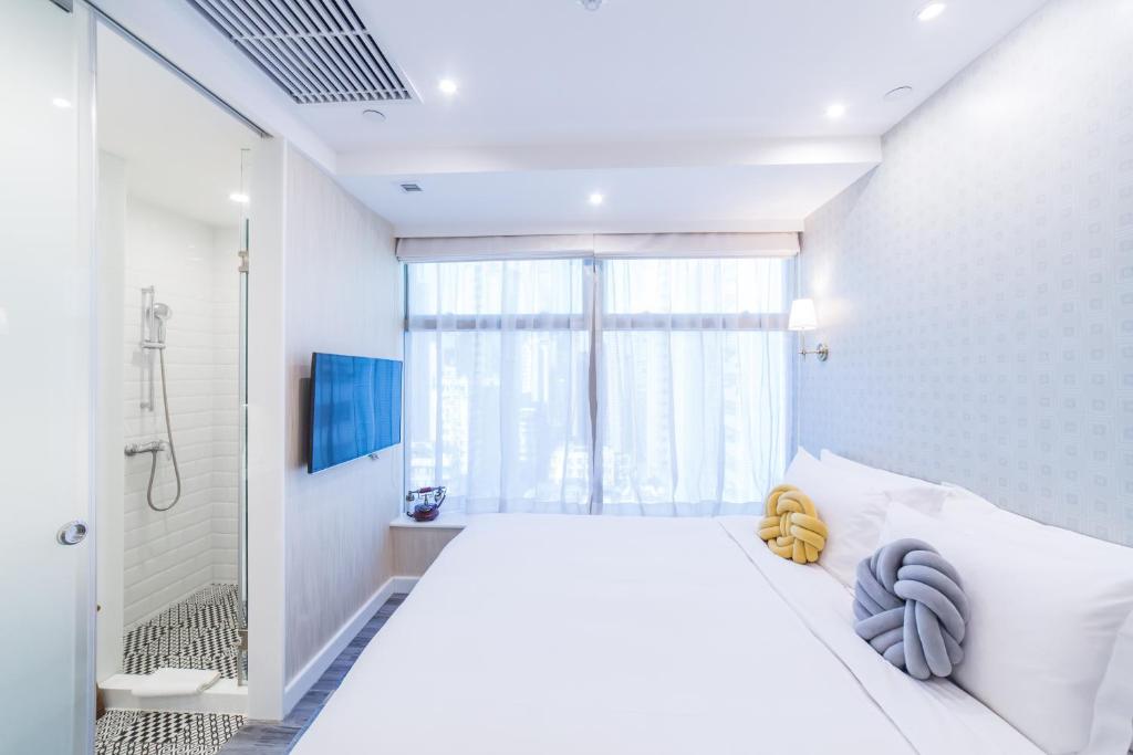 Voodi või voodid majutusasutuse Tung Nam Lou Art Hotel toas