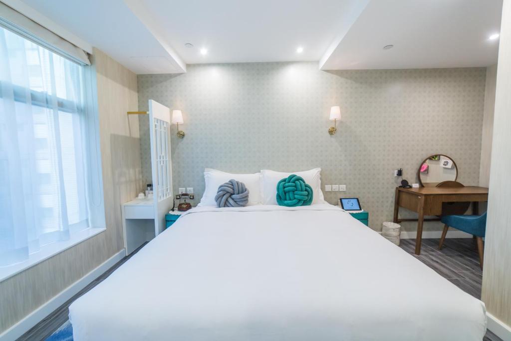 Voodi või voodid majutusasutuse Tung Nam Lou Art Hotel toas
