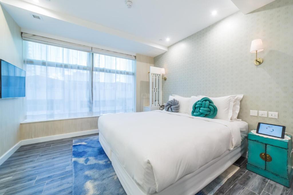 Voodi või voodid majutusasutuse Tung Nam Lou Art Hotel toas