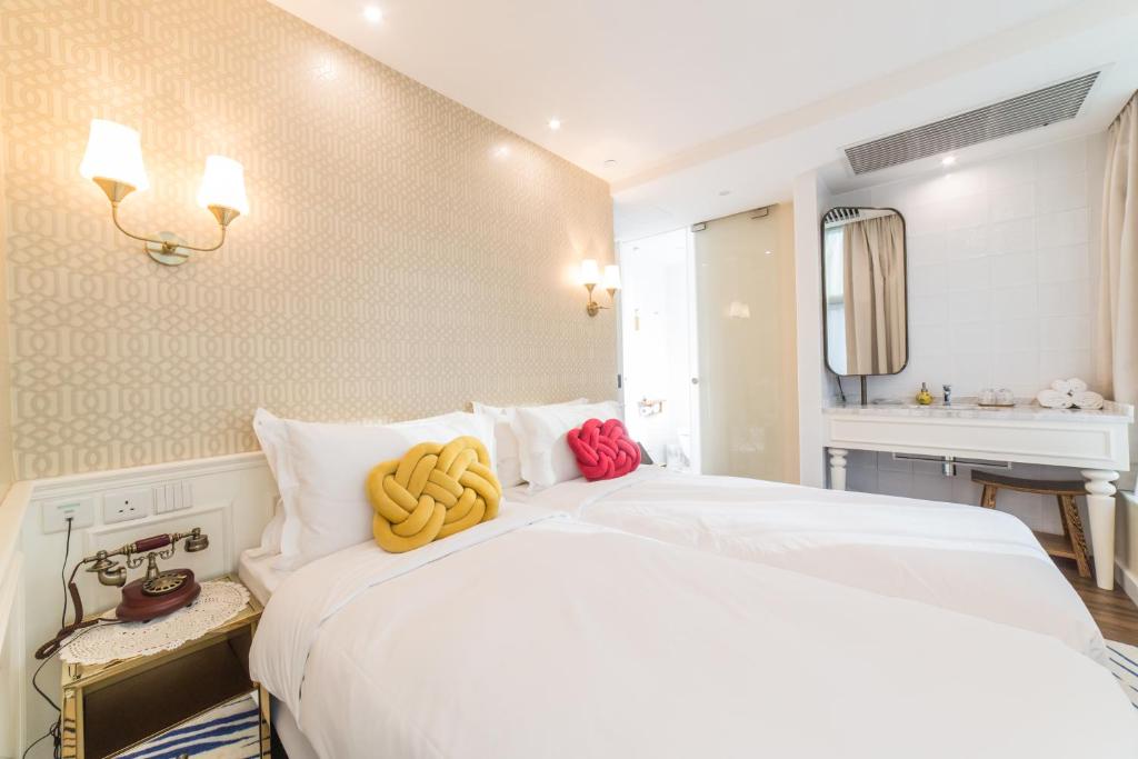 Voodi või voodid majutusasutuse Tung Nam Lou Art Hotel toas