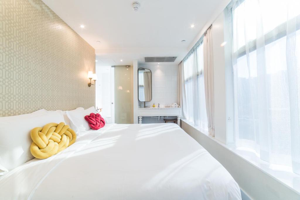 Voodi või voodid majutusasutuse Tung Nam Lou Art Hotel toas