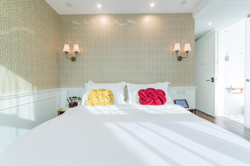 Voodi või voodid majutusasutuse Tung Nam Lou Art Hotel toas