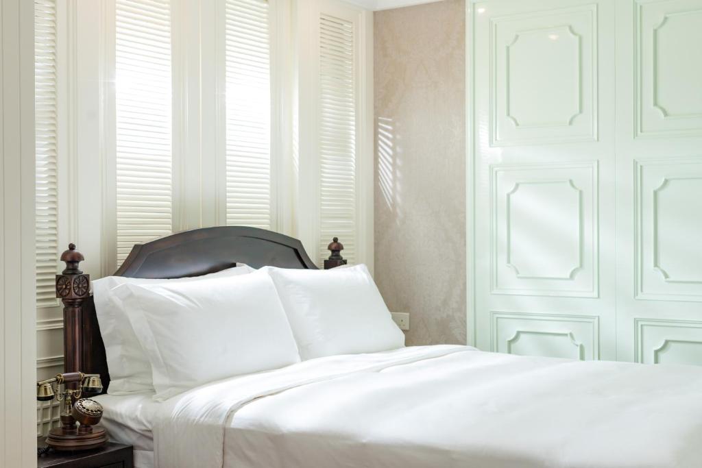 Voodi või voodid majutusasutuse Tung Nam Lou Art Hotel toas