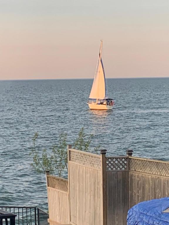 a sail boat in the water with a fence at Lakeview Villa - Enjoy luxury Vacation at its Best! in Hamilton