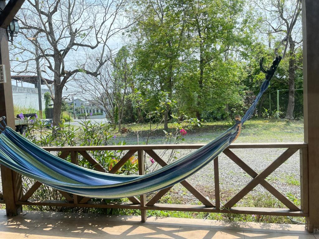 a blue hammock hanging on a wooden fence at Star Wish B&amp;B in Dongshan