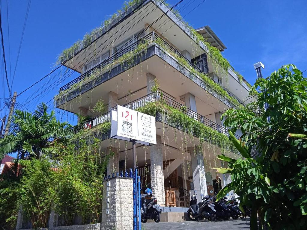 een gebouw met een bord ervoor bij MURAI Guesthouse Bali in Denpasar