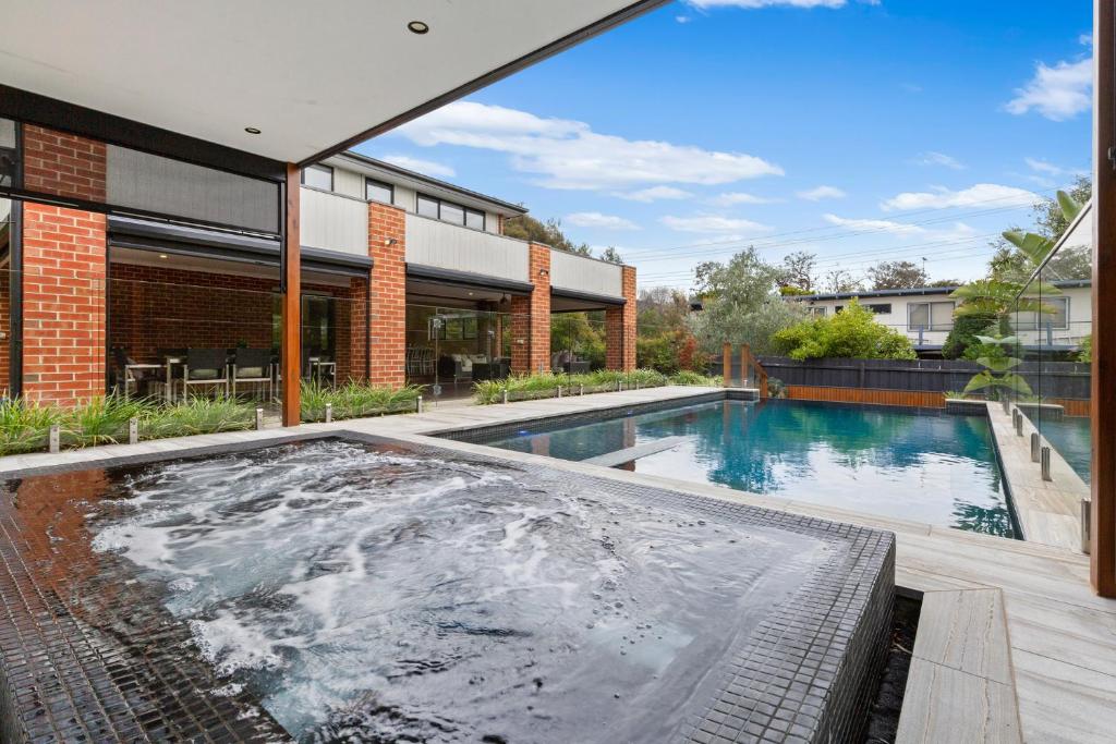 a swimming pool in the backyard of a house at St Tropez in Blairgowrie