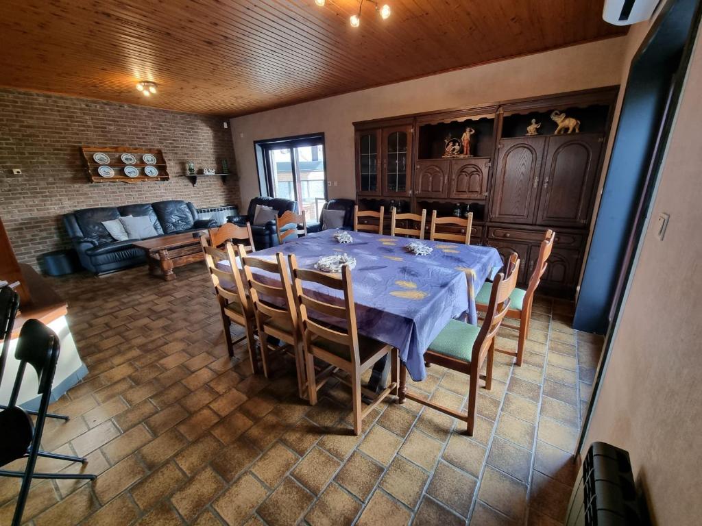 a dining room with a blue table and chairs at Maison de vacances située entre Liège, Tongres et Visé 