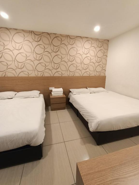Postel nebo postele na pokoji v ubytování DYAYA Hotel
