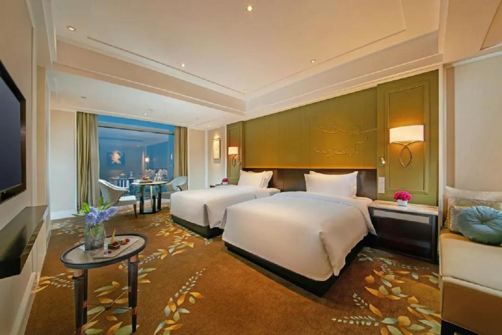 Postel nebo postele na pokoji v ubytování Wen Ling International Hotel