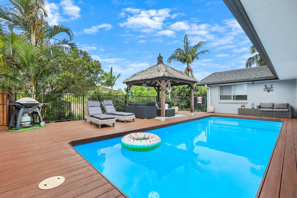 a swimming pool in a backyard with a gazebo at Chic Miami 4BR Retreat with Swimming Pool & BBQ in Gold Coast