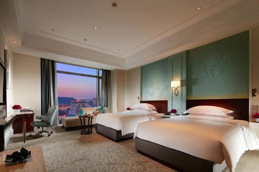 Postel nebo postele na pokoji v ubytování Wen Ling International Hotel