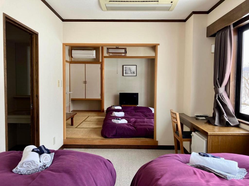 Postel nebo postele na pokoji v ubytování Morino Lodge - Myoko