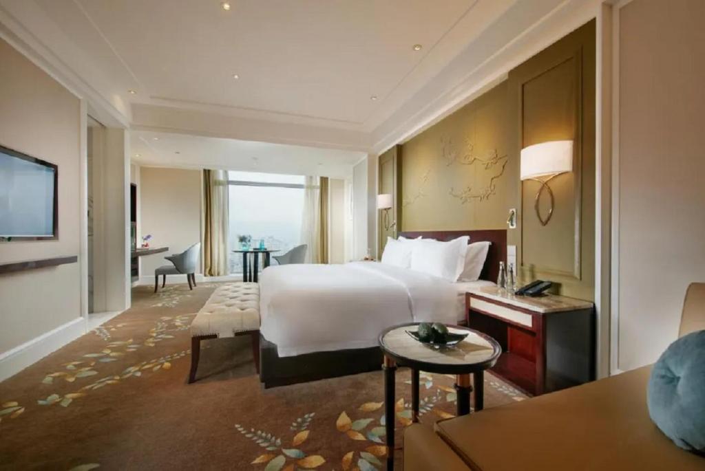Postel nebo postele na pokoji v ubytování Wen Ling International Hotel