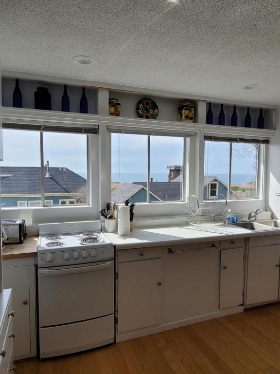 a kitchen with a stove and a sink and windows at Mendocino Art Center in Mendocino