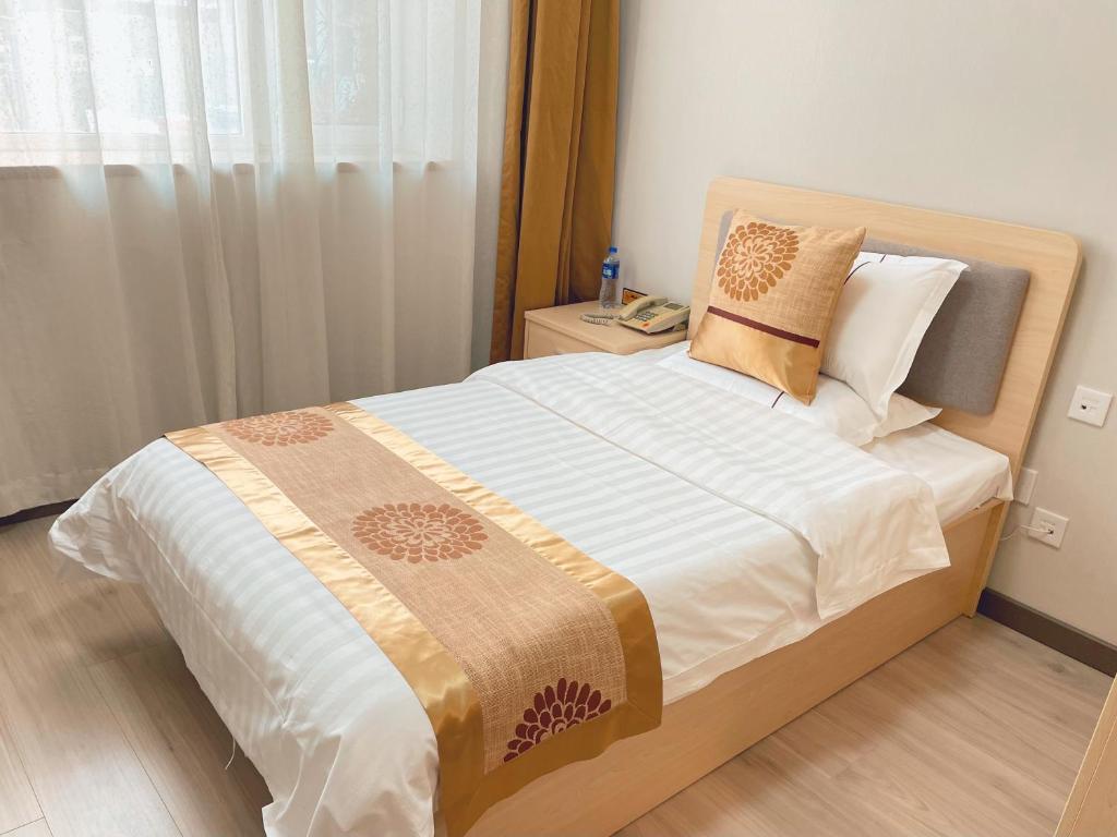 Postel nebo postele na pokoji v ubytování King Parkview Hotel