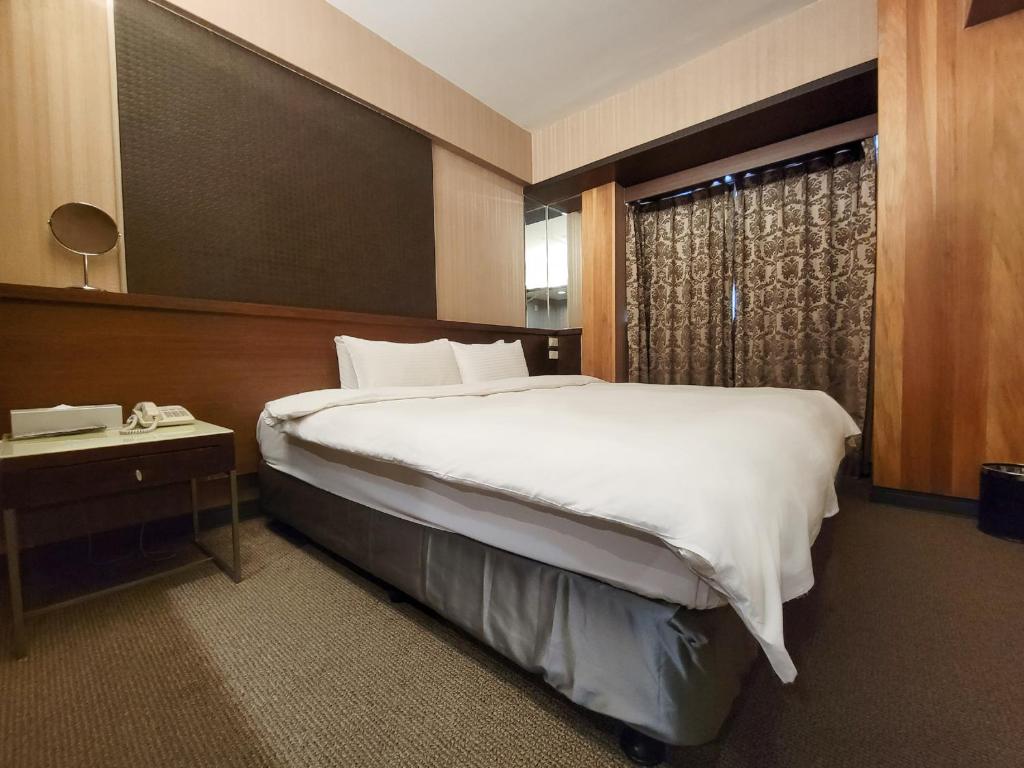 a hotel room with a large bed and a window at CHECK inn Express Taichung Fengchia in Taichung