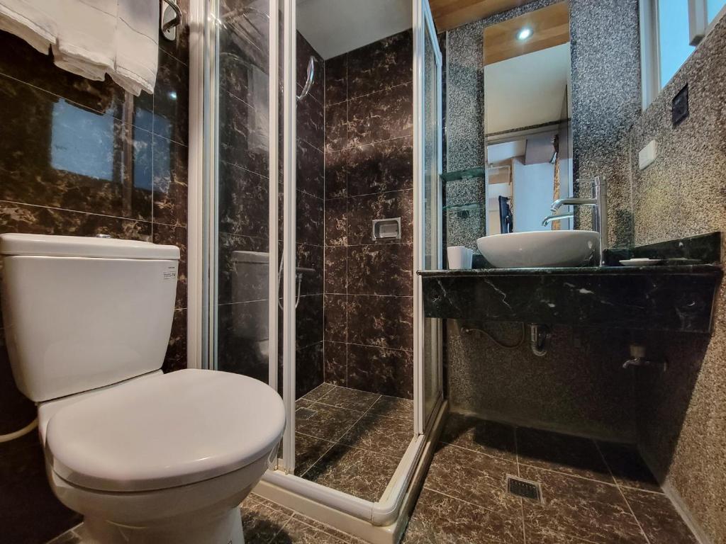 a bathroom with a toilet and a shower and a sink at CHECK inn Express Taichung Fengchia in Taichung