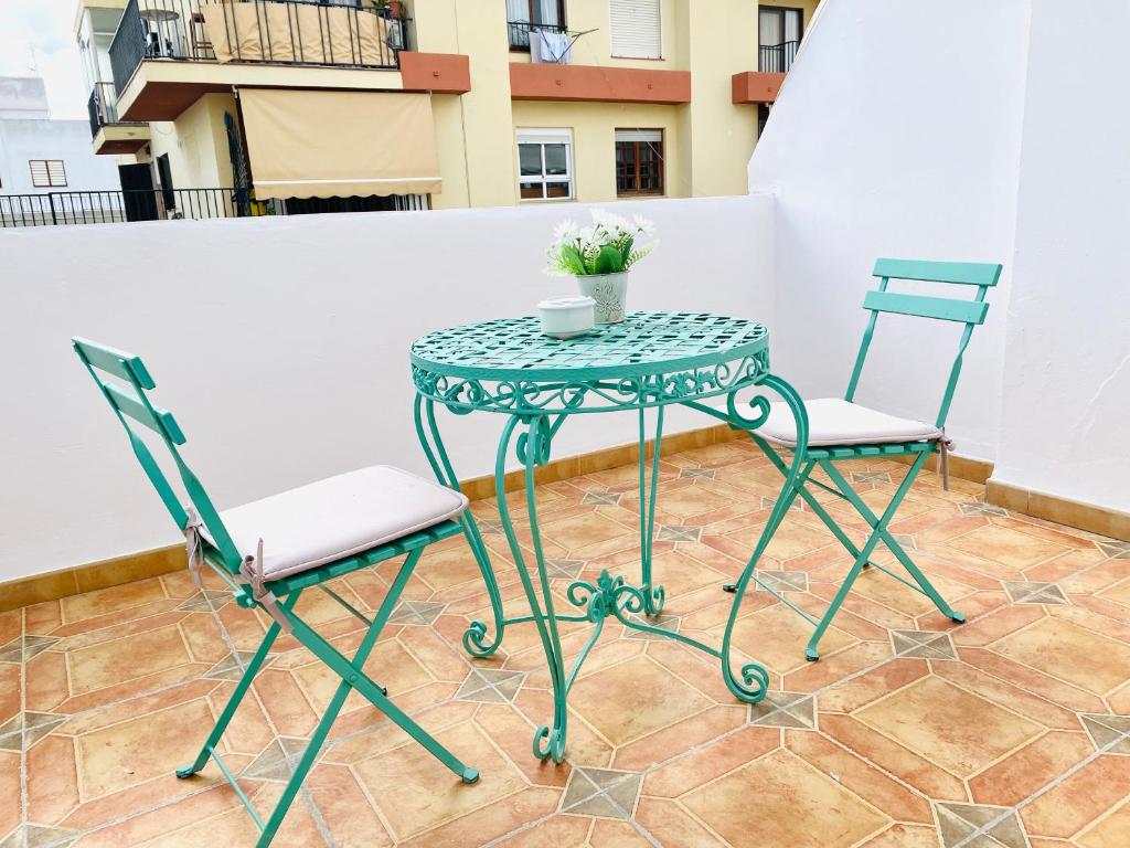 La Bartola Guesthouse في مدينة إيبيزا: طاولة و كرسيين يجلسون على شرفة