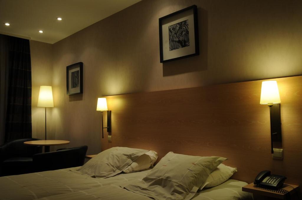 Postel nebo postele na pokoji v ubytování Hotel Escapade