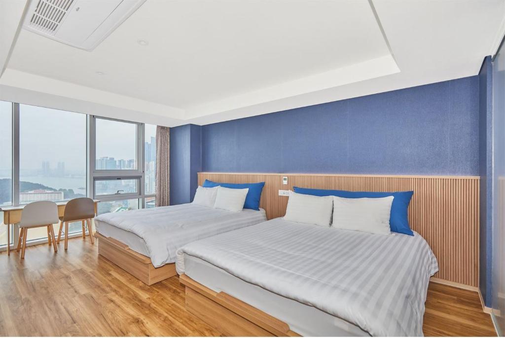 Postel nebo postele na pokoji v ubytování Kolon Seacloud Hotel
